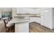 Bright white kitchen features modern appliances, light countertops, and stylish breakfast bar overlooking the dining area at 7393 West Lenox Cir, Punta Gorda, FL 33950