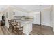 Bright kitchen features white cabinets, stainless appliances, marble countertops, and island seating at 7393 West Lenox Cir, Punta Gorda, FL 33950
