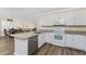 Kitchen featuring white cabinets, modern stainless appliances, and an island bar at 7393 West Lenox Cir, Punta Gorda, FL 33950