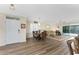 Open concept living space with wood floors, front door, and abundant natural light at 7393 West Lenox Cir, Punta Gorda, FL 33950