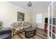 Cozy living room featuring a floral sofa, coffee table, and window shutters at 7393 West Lenox Cir, Punta Gorda, FL 33950