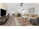 Comfortable living room with hardwood floors, ceiling fan, and great natural light at 7393 West Lenox Cir, Punta Gorda, FL 33950