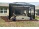 View of screened patio with tile floor and access to the fenced backyard at 7393 West Lenox Cir, Punta Gorda, FL 33950