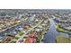 An aerial view of a waterfront residential area, showcasing the canal system and residences with private docks and meticulous landscaping at 805 Via Formia, Punta Gorda, FL 33950