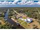 Aerial view of a waterfront property with canal access, boat dock, and a screened-in pool area at 1052 Eppinger Dr, Port Charlotte, FL 33953