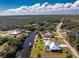 This aerial showcases a charming waterfront property with a boat lift and a screened lanai at 1052 Eppinger Dr, Port Charlotte, FL 33953
