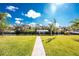 Lush backyard with a paved pathway leading to the water at 1052 Eppinger Dr, Port Charlotte, FL 33953