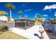 Expansive waterfront backyard featuring a screened lanai, providing a serene outdoor living space at 1052 Eppinger Dr, Port Charlotte, FL 33953