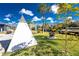 Private backyard with a teepee and fire pit, perfect for outdoor gatherings at 1052 Eppinger Dr, Port Charlotte, FL 33953