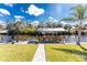 Waterfront home with a private boat dock, lush lawn, and landscaping with an outdoor entertainment space at 1052 Eppinger Dr, Port Charlotte, FL 33953