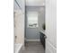 Well-lit bathroom featuring modern fixtures, a vanity, and a shower with white tile at 1052 Eppinger Dr, Port Charlotte, FL 33953