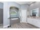 Spacious bathroom with a walk-in shower, soaking tub and wood-look vinyl flooring at 1052 Eppinger Dr, Port Charlotte, FL 33953