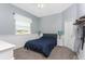 Cozy bedroom with gray carpet, wainscotting and a comfy queen bed at 1052 Eppinger Dr, Port Charlotte, FL 33953
