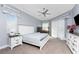 Bright bedroom featuring a ceiling fan, a large window and a queen-sized bed at 1052 Eppinger Dr, Port Charlotte, FL 33953
