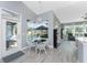 Breakfast nook with chandelier and views of pool and outdoor living space at 1052 Eppinger Dr, Port Charlotte, FL 33953