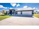 Charming one-story home featuring a well-manicured lawn and an attached three-car garage at 1052 Eppinger Dr, Port Charlotte, FL 33953