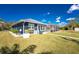 Exterior view of a charming home featuring a screened-in porch and mature landscaping at 1052 Eppinger Dr, Port Charlotte, FL 33953
