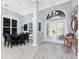 Elegant foyer with high ceilings, chandelier, hardwood floors, and decorative front door, with adjacent dining area at 1052 Eppinger Dr, Port Charlotte, FL 33953
