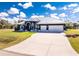 Attractive home featuring a well-manicured lawn, driveway, and metal roof at 1052 Eppinger Dr, Port Charlotte, FL 33953