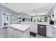 Bright and airy kitchen with island, stainless steel appliances, ample counter space and adjacent dining area with backyard views at 1052 Eppinger Dr, Port Charlotte, FL 33953