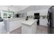 Open-concept kitchen with stainless steel appliances, modern backsplash, island and seamless flow to living space at 1052 Eppinger Dr, Port Charlotte, FL 33953