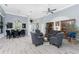 Open-concept living room with high ceilings, arched windows, and lots of seating for entertaining at 1052 Eppinger Dr, Port Charlotte, FL 33953