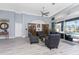 Living room with high ceilings, natural light, and easy access to outdoor patio and pool area at 1052 Eppinger Dr, Port Charlotte, FL 33953