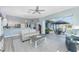 Open living room with neutral colors, opening to stainless kitchen and lanai with summer kitchen and pool at 1052 Eppinger Dr, Port Charlotte, FL 33953