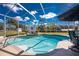Sparkling pool with a screen enclosure and lush landscaping at 1052 Eppinger Dr, Port Charlotte, FL 33953