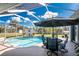 Sparkling pool with a screen enclosure and outdoor seating area at 1052 Eppinger Dr, Port Charlotte, FL 33953