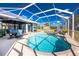 Beautiful pool area with screen enclosure, outdoor seating and landscaping at 1052 Eppinger Dr, Port Charlotte, FL 33953