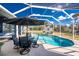 Beautiful pool area with screen enclosure, outdoor seating and landscaping at 1052 Eppinger Dr, Port Charlotte, FL 33953
