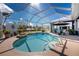 Screened-in pool area with a spa and lounge chairs offering a relaxing outdoor space at 1052 Eppinger Dr, Port Charlotte, FL 33953