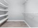 Empty walk-in closet featuring wood-look vinyl flooring and white shelving at 1052 Eppinger Dr, Port Charlotte, FL 33953