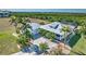 Beautiful single-Gathering home with a metal roof, screened lanai, and tropical landscaping in a coastal setting at 17455 Boca Vista Rd, Punta Gorda, FL 33955