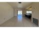 Open living area featuring tile floors, sliders to the screened porch, and a breakfast bar at 2491 Shenandoah St, North Port, FL 34287