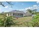 Spacious backyard featuring a screened lanai perfect for outdoor relaxation at 3896 Slayton Ave, North Port, FL 34286