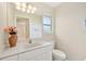 Bright bathroom with a well-lit vanity, mirror, and a window providing natural light at 3896 Slayton Ave, North Port, FL 34286