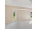 Spacious bedroom with carpet, fan, and two windows at 3896 Slayton Ave, North Port, FL 34286
