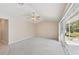 Neutral bedroom with carpet, fan, and glass sliding doors at 3896 Slayton Ave, North Port, FL 34286
