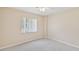 Bright bedroom featuring a ceiling fan and a large window with natural light at 3896 Slayton Ave, North Port, FL 34286