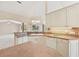 Bright and airy kitchen with tile flooring, ample cabinetry, and functional island at 3896 Slayton Ave, North Port, FL 34286