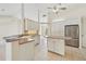 Well-appointed kitchen featuring tile flooring, stainless steel appliances, and convenient island at 3896 Slayton Ave, North Port, FL 34286
