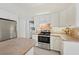 Bright kitchen features white cabinets, tile floor, stainless steel appliances and spacious island at 3896 Slayton Ave, North Port, FL 34286
