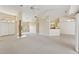 Open-concept living room with tile flooring, natural light, and seamless flow into kitchen area at 3896 Slayton Ave, North Port, FL 34286