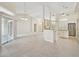 Open-concept living room with tile flooring, natural light, and seamless flow into kitchen area at 3896 Slayton Ave, North Port, FL 34286