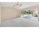 Spacious living room featuring a ceiling fan and sliding glass doors to the lanai at 3896 Slayton Ave, North Port, FL 34286