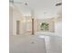 Bright and airy living room features tile and carpet flooring, high ceilings, and large windows at 3896 Slayton Ave, North Port, FL 34286