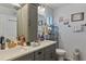 This main bathroom boasts double sinks, granite countertops, and a framed mirror at 9 Logan St, Port Charlotte, FL 33954