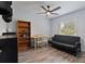 Bright bedroom with a futon, ceiling fan, and wood-look floors at 9 Logan St, Port Charlotte, FL 33954